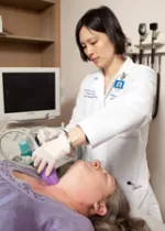 A female fellow helping a patient