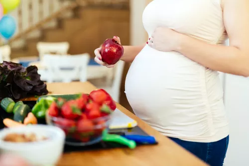 Pregnant woman with fruits and vegetables