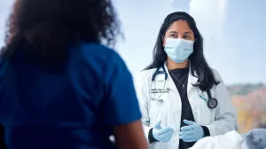 Dr. Koneru consulting with nurse about patient care on Med5 at MelroseWakefield Hospital.