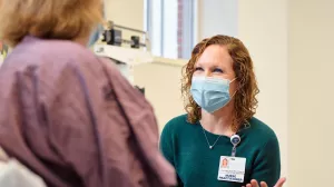 Jennifer Gilliatt, Oncology Nurse Practitioner, meeting with a patient during an appointment at Lowell General Hospital's Women's Wellness Center.