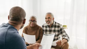 A couple meets with financial advisor to go over their estate planning documents.