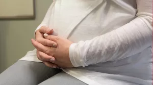 Pregnant woman holding stomach