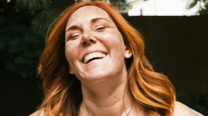 Woman in 40s with red hair smiling