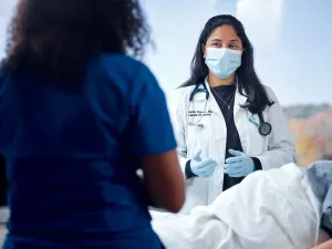 Dr. Koneru consulting with nurse about patient care on Med5 at MelroseWakefield Hospital.