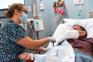 Nurse in the infusion center taking care of patient.