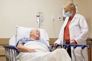 Allayne Mendys, RN (Director of Cadiovascular Services at Lowell General Hospital) talks to patient before his cardiac surgery.