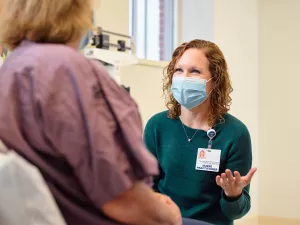 Jennifer Gilliatt, Oncology Nurse Practitioner, meeting with a patient during an appointment at Lowell General Hospital's Women's Wellness Center.