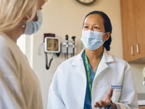 Dr. Mary Lynn Joe, Chief of Urgent Care at Lowell General Hospital's Tewksbury location consults with a patient.