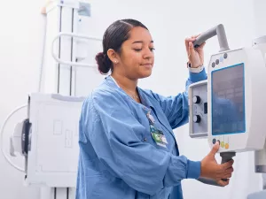 Lowell General Hospital employee operating an x-ray machine at the Tewksbury Urgent Care location.