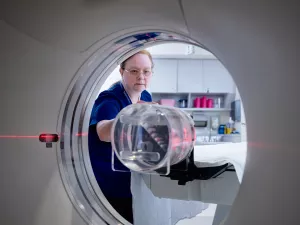 Patricia Byrne, CT Technologist, setting up CT scanner for appointment.