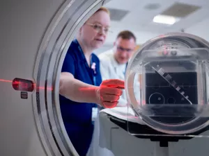 Patricia Byrne, CT Technologist, and John Seccareccio, Director Imaging Services, setting up CT scanner.