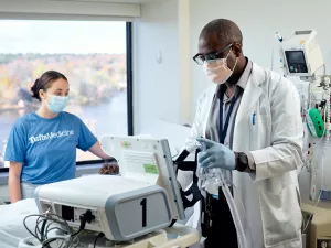 Palcide Colas, RRT (Respiratory Therapist) and Gianna Faysal, Clinical Leader Nursing, treating sleep medicine patient with a CPAP at MelroseWakefield Hospital in the Med5 inpatient unit.