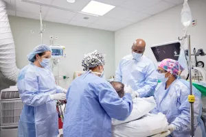 Amber Gross, SRNA (nurse assistant), Heidi MacFarlane, RN, Jason Hall, MD and Sharma Joseph, MD preparing patient for colon and rectal surgery