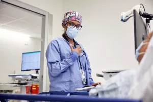 Dr. Sharma Joseph, Attending Anesthesiology Physician, talking to and preparing patient for endoscopy procedure.