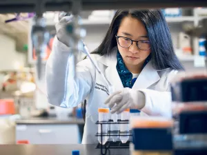 MIRI Research Assistant, Francesca Carasi-Schwartz, using a pipette with test tubes in Tupper Research Building lab. 