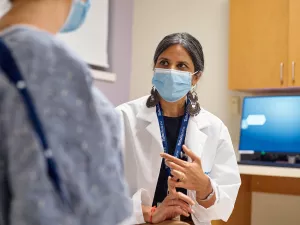 Anasuya Gunturi MD, PhD talks with patient at Lowell General Hospital's Women's Wellness Center clinic appointment.