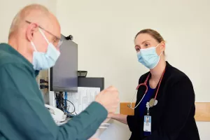 Amanda Vest, MD, Director of the Advanced Heart Failure Program at Tufts Medical Center, is talking to cardiovascular patient during a clinic appointment.