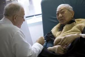 Klemens Meyer, MD, Director of Dialysis Services at Tufts Medical Center, attends to patient as he receives dialysis treatment at the outpatient clinic.