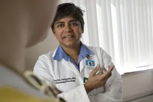 Neuro-oncologist Suriya Jeyapalan, MD, MPH sees a patient in clinic appointment at Tufts Medical Center's Cancer Center.