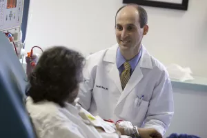 Outpatient Dialysis Center's patient speaks with Daniel Weiner, MD, MS, FNKF, during the dialysis at Tufts Medical Center.