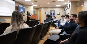 CRA radiologist at Tufts Medical Center lecturing to a group about a research topic.