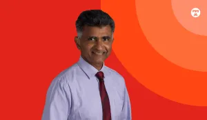Doctor in front of color background with Tufts Medicine brand. 