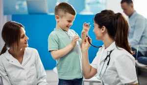 Child with clinicians, laughing