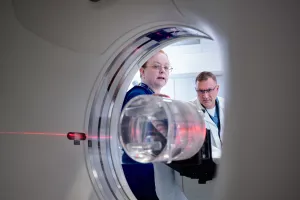 Patricia Byrne, CT Technologist, and John Seccareccio, Director Imaging Services, setting up CT scanner.