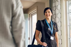 Care at Home's Rebecca Clementi, RN greets patient in their home during appointment.