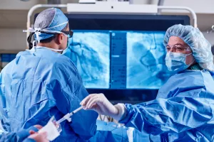 Doctor and nurse working together during a surgery in Lowell General Hospital's Heart and Vascular Cath Lab.