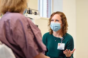 Jennifer Gilliatt, Oncology Nurse Practitioner, meeting with a patient during an appointment at Lowell General Hospital's Women's Wellness Center.