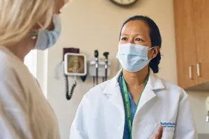 Dr. Mary Lynn Joe, Chief of Urgent Care at Lowell General Hospital's Tewksbury location consults with a patient.