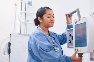 Lowell General Hospital employee operating an x-ray machine at the Tewksbury Urgent Care location.