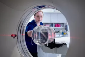 Patricia Byrne, CT Technologist, setting up CT scanner for appointment.