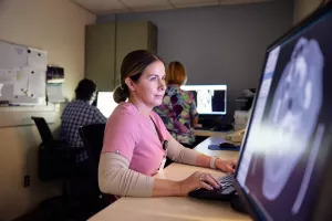 Jennifer BaRoss, Melrose Wakefield Hospital employee, working at the MRI computer station and reviewing scan.