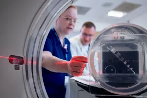 Patricia Byrne, CT Technologist, and John Seccareccio, Director Imaging Services, setting up CT scanner.