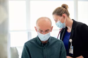 Amanda Vest, MD, Director of the Advanced Heart Failure Program at Tufts Medical Center, is checking patient with a stethoscope during appointment.