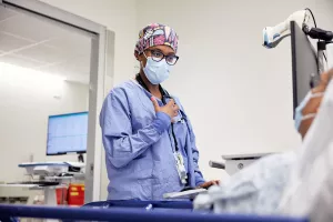 Dr. Sharma Joseph, Attending Anesthesiology Physician, talking to and preparing patient for endoscopy procedure.