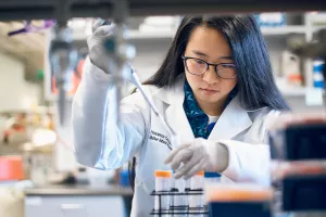 MIRI Research Assistant, Francesca Carasi-Schwartz, using a pipette with test tubes in Tupper Research Building lab. 