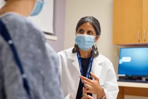 Anasuya Gunturi MD, PhD talks with patient at Lowell General Hospital's Women's Wellness Center clinic appointment.