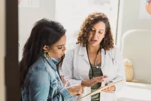 Doctor discussing a treatment plan and test results with patient during a clinic appointment.