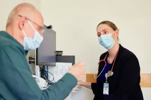 Amanda Vest, MD, Director of the Advanced Heart Failure Program at Tufts Medical Center, is talking to cardiovascular patient during a clinic appointment.