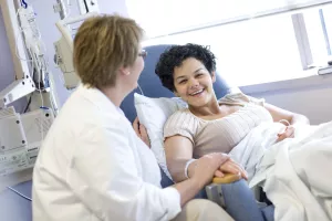 erry Fogarew, RN comforting Infusion Center patient at Tufts Medical Center.