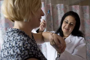 Tufts Medical Center's Physiatrist Rina M. Bloch, MD treats examines patient in a clinic appointment.