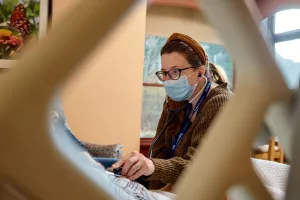 Charlotte Grinberg, MD examining hospice patient's heart with a stethocope at Care at Home's High Pointe House.