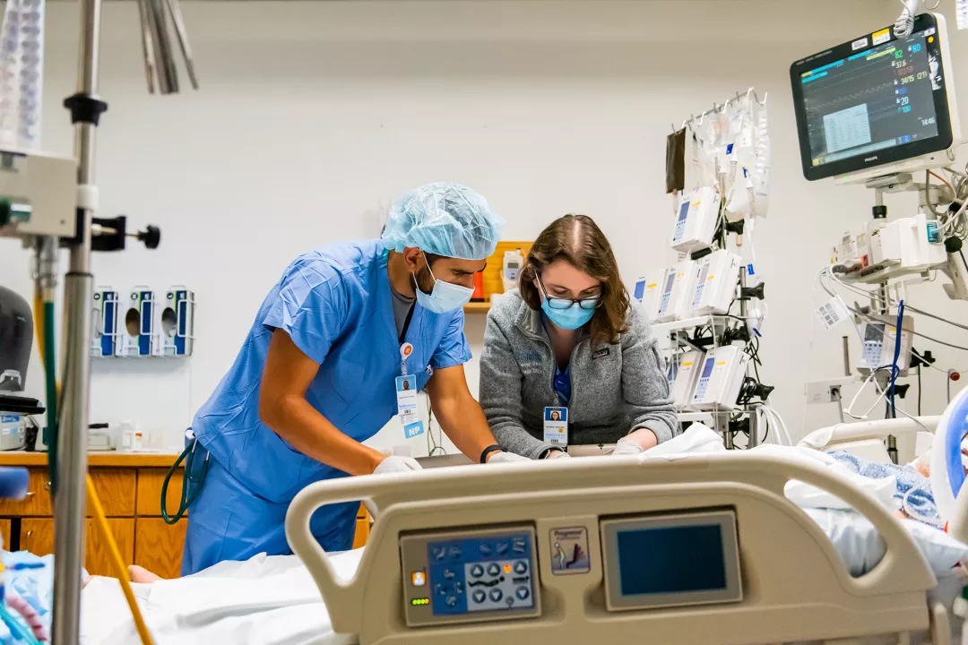 Christopher Rago, NP and Marcelle Tuttle, MD treating a patient in the Critical Care Unit (CCU) at Tufts Medical Center.