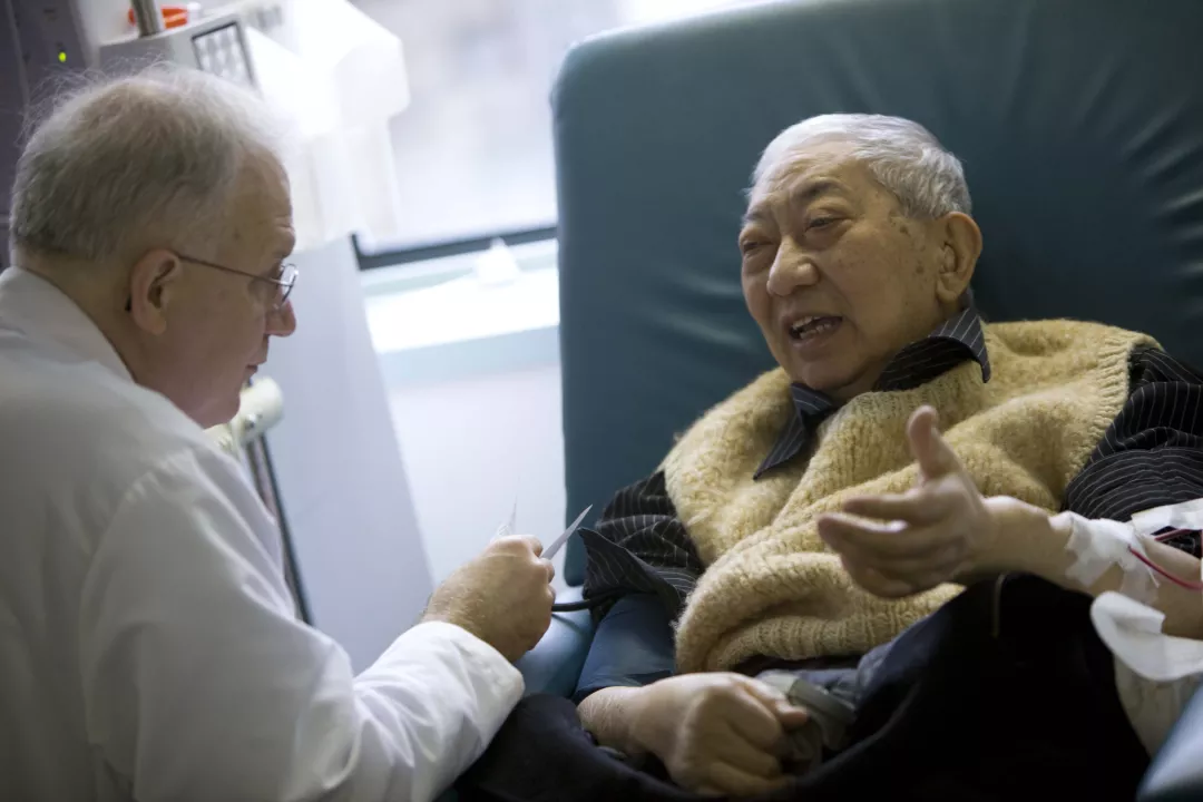 Klemens Meyer, MD, Director of Dialysis Services, attends patient as he receives dialysis treatment at the outpatient clinic at Tufts Medical Center.