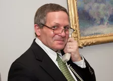 Dr. Erban talking on a phone Dr. Erban talking on a phone